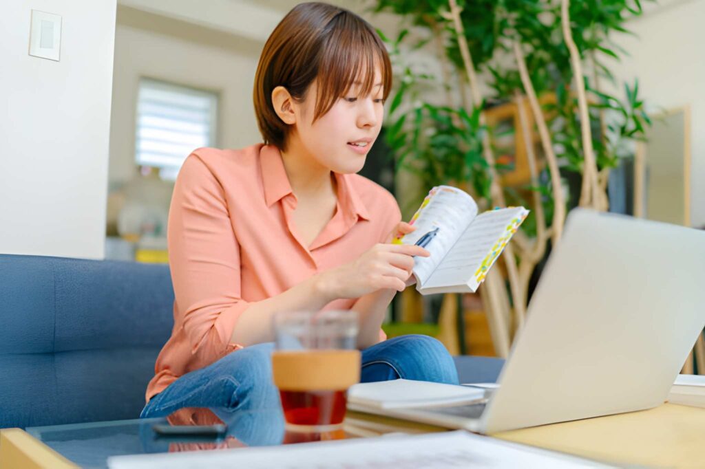 Custom travel planner in Japan designing a personalized trip itinerary on laptop